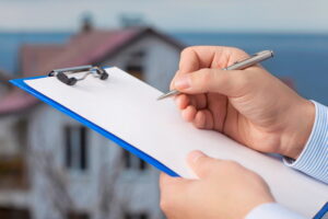 hand-writing-on-paper-on-clipboard