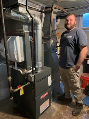 McDaniel technician standing in front of a furnace
