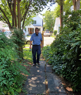 McDaniel technician walking up a sidewalk