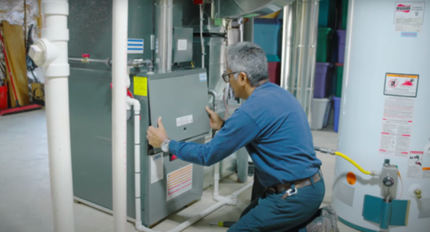 McDaniel technician working on a furnace