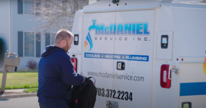 McDaniel technician standing in front of van