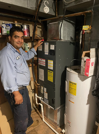 Technician standing in front of a furnace