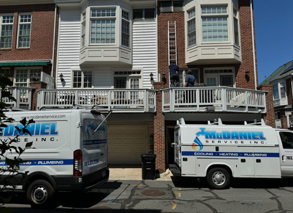 McDaniel service vehicles in front of a residence